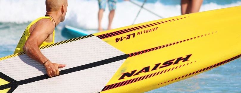 man carrying Paddle Boards